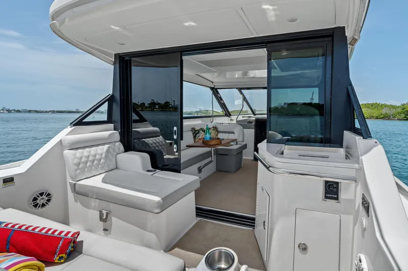 Slide: The Image of Luxurious 2022 Regal boat interior with seating, table, and water view. - 16