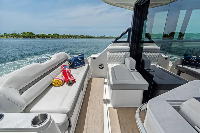 Slide: The Image of Luxurious 2022 Regal boat interior with plush seating, towels, and scenic water view. - 19