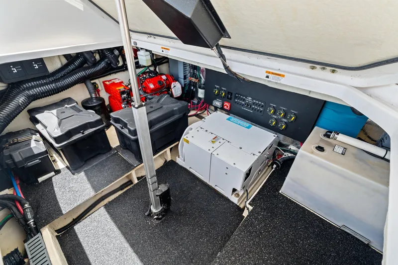 Slide: The Image of Engine compartment of a 2022 Regal boat, featuring batteries and control panels. - 37