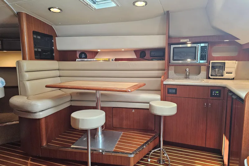 Slide: The Image of Interior of 2003 Tiara Yachts 3800 Open with dining area and kitchenette. - 7