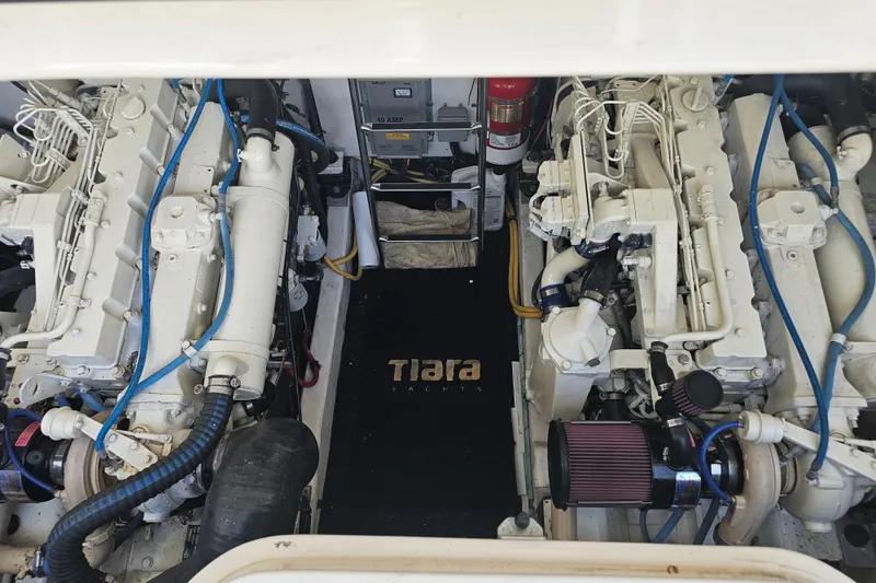 Slide: The Image of Engine room of a 2003 Tiara Yachts 3800 Open, showcasing dual engines and equipment. - 18