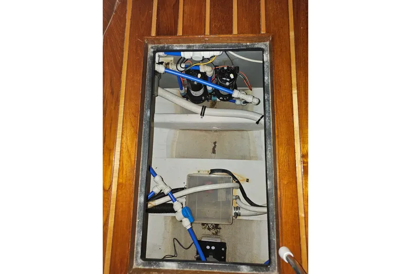 Slide: The Image of Bilge compartment of 2003 Tiara Yachts 3800 Open, showcasing plumbing and wiring. - 14