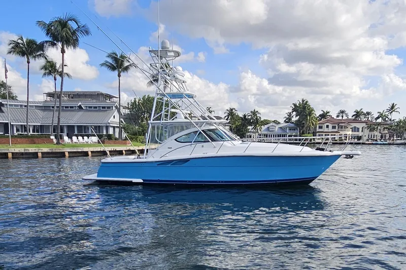 The Image of 2003 Tiara Yachts 3800 Open boat on water near palm trees and houses. - 0