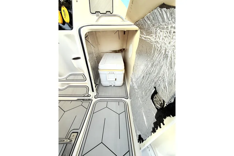 Slide: The Image of 2005 Hydra-Sports 3300 VX interior with storage compartment and cooler. - 9