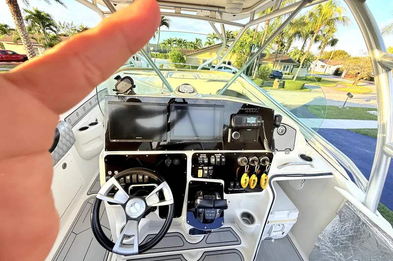 Slide: The Image of 2005 Hydra-Sports 3300 VX boat cockpit with steering wheel and navigation controls. - 16