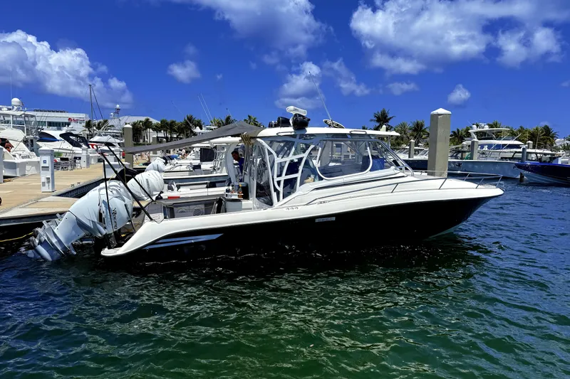 The Image of 2005 Hydra-Sports 3300 VX boat docked at marina under clear blue sky. - 2