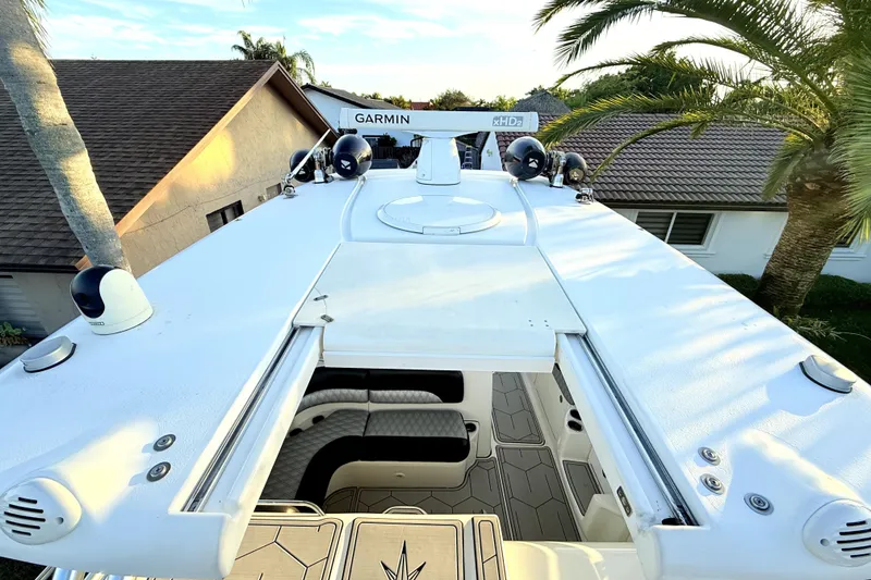 Slide: The Image of 2005 Hydra-Sports 3300 VX boat with Garmin equipment, docked near palm trees. - 8