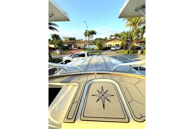 Slide: The Image of 2005 Hydra-Sports 3300 VX boat deck with compass rose design, parked in a residential area. - 11