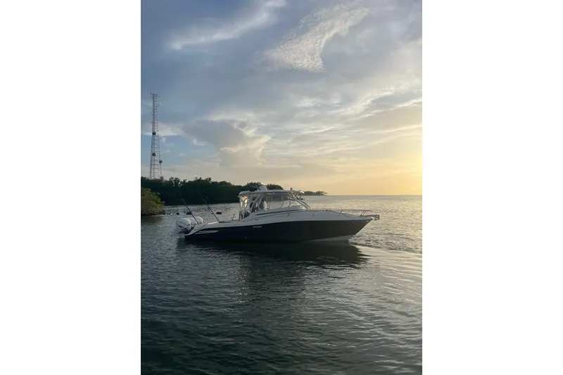 Slide: The Image of 2005 Hydra-Sports 3300 VX boat on calm water at sunset. - 5