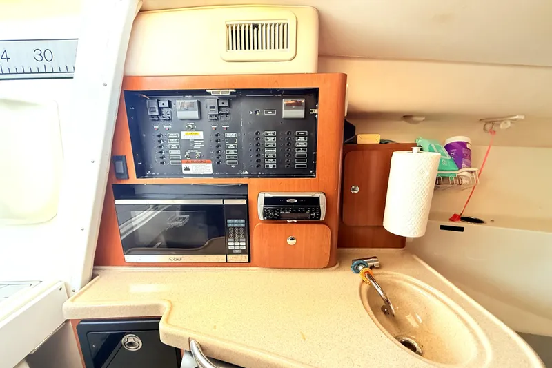 Slide: The Image of 2005 Hydra-Sports 3300 VX cabin interior with control panel, microwave, and sink. - 14