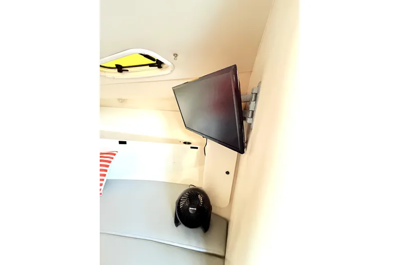 Slide: The Image of Interior of 2005 Hydra-Sports 3300 VX with mounted TV and fan. - 13