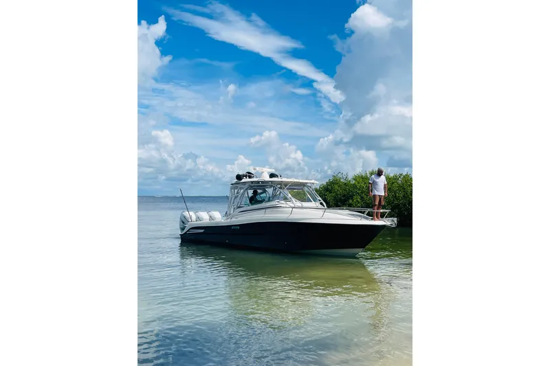 Slide: The Image of 2005 Hydra-Sports 3300 VX boat anchored in shallow water under a blue sky. - 4