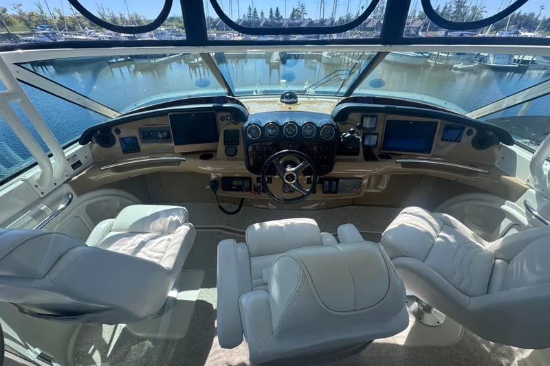 Slide: The Image of Luxurious helm of 2004 Carver 466 Motor Yacht with leather seating and advanced navigation controls. - 9