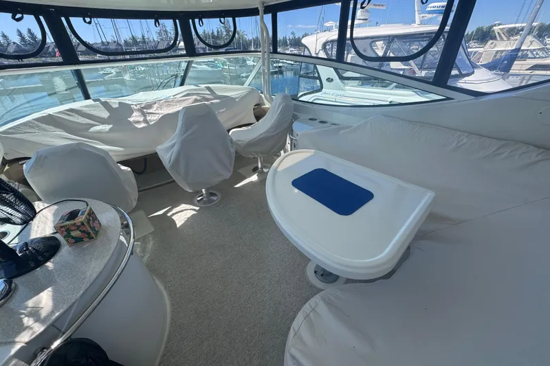 Slide: The Image of Interior of 2004 Carver 466 Motor Yacht with covered seating and table. - 4