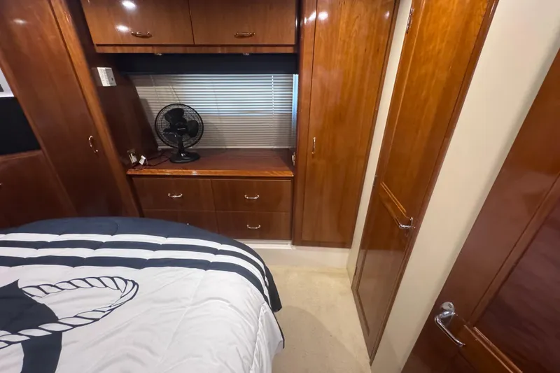 Slide: The Image of Interior of 2004 Carver 466 Motor Yacht with wood cabinetry and bed. - 23