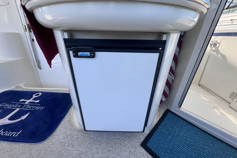 Slide: The Image of 2004 Carver 466 Motor Yacht interior with fridge and nautical-themed decor. - 45