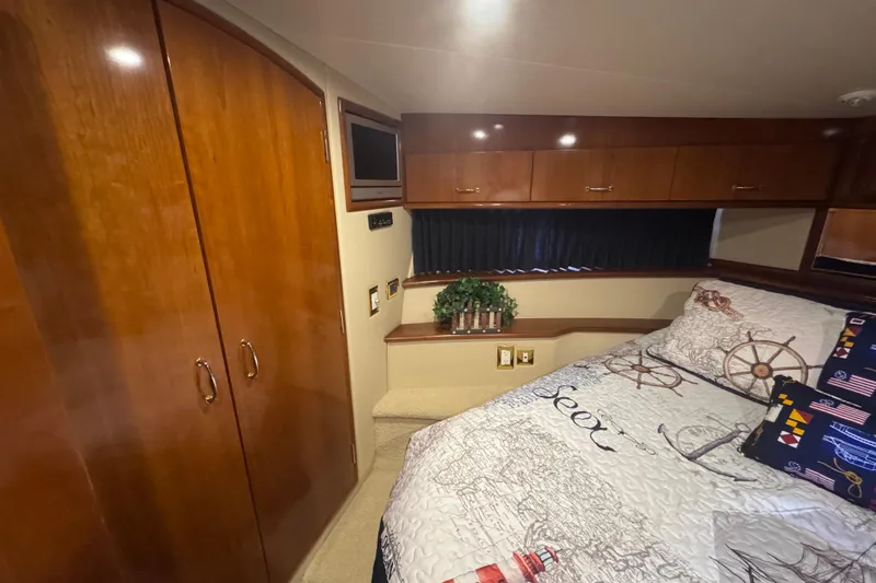 Slide: The Image of Interior of 2004 Carver 466 Motor Yacht bedroom with nautical-themed bedding. - 36