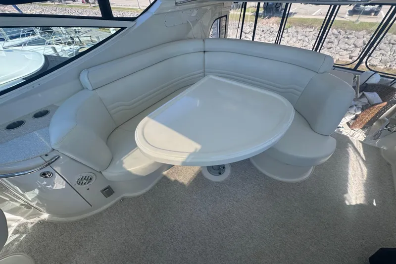 Slide: The Image of Luxurious seating area on 2004 Carver 466 Motor Yacht with elegant white upholstery. - 10