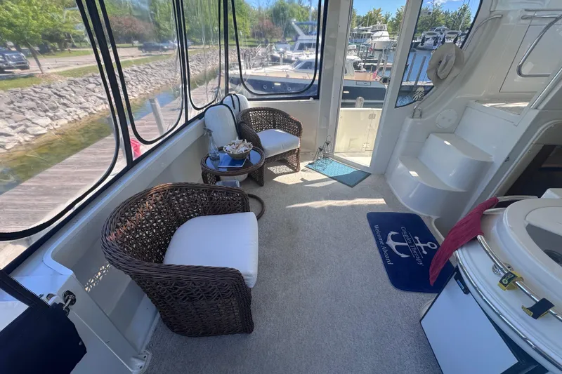 Slide: The Image of Luxurious interior of 2004 Carver 466 Motor Yacht with wicker chairs and scenic views. - 11