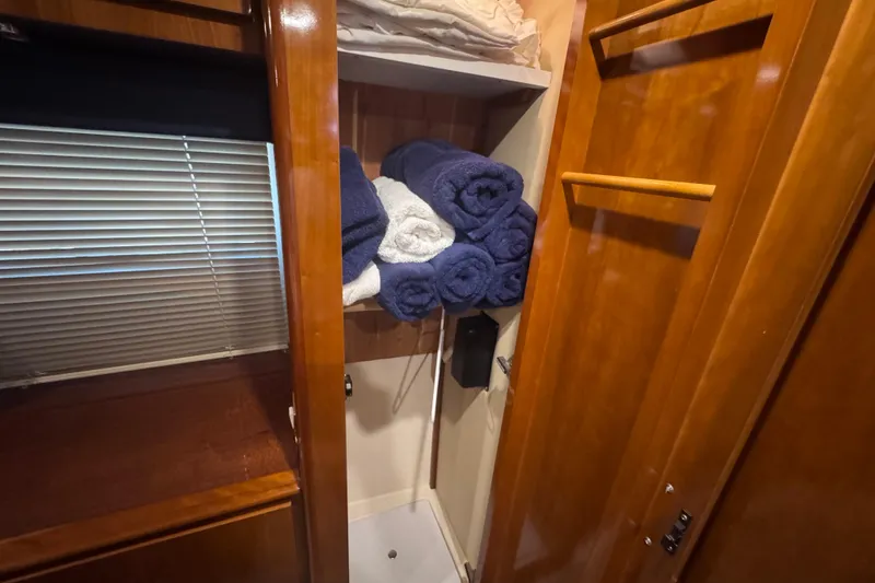 Slide: The Image of Storage area with towels in a 2004 Carver 466 Motor Yacht. - 25