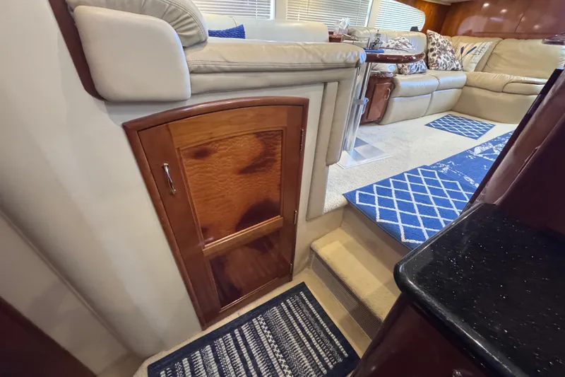 Slide: The Image of Interior of 2004 Carver 466 Motor Yacht with beige seating and blue rugs. - 29