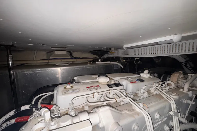 Slide: The Image of Engine room of a 2004 Carver 466 Motor Yacht, showcasing mechanical components and wiring. - 52
