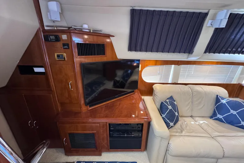 Slide: The Image of Luxurious interior of 2004 Carver 466 Motor Yacht with TV and plush seating. - 13