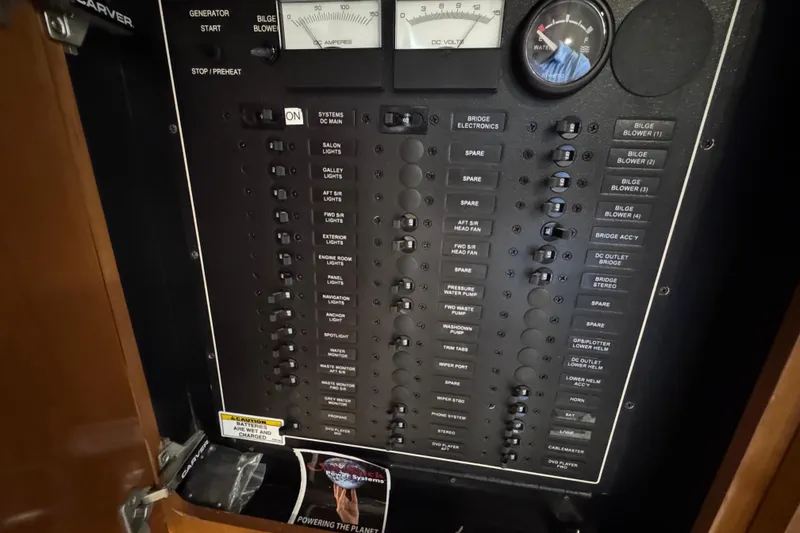 Slide: The Image of Electrical panel of a 2004 Carver 466 Motor Yacht with various switches and gauges. - 19
