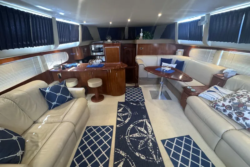 Slide: The Image of Luxurious interior of 2004 Carver 466 Motor Yacht with elegant seating and nautical decor. - 12