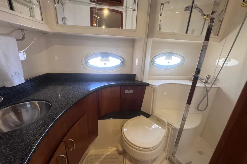 Slide: The Image of Luxurious bathroom in 2004 Carver 466 Motor Yacht with modern fixtures and porthole windows. - 24