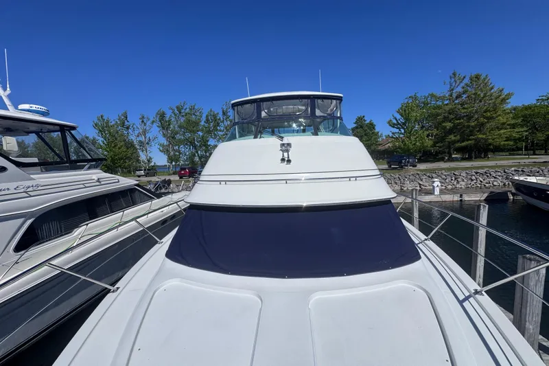 Slide: The Image of 2004 Carver 466 Motor Yacht docked at marina under clear blue sky. - 40