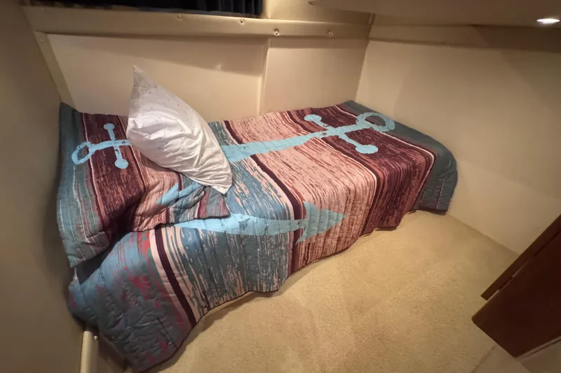 Slide: The Image of Cozy cabin bed in 2004 Carver 466 Motor Yacht with nautical-themed bedding. - 28