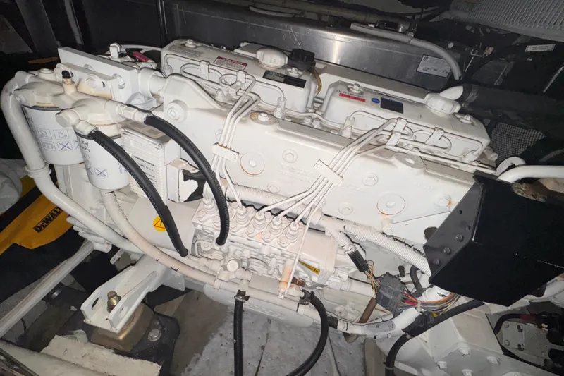 Slide: The Image of Engine compartment of a 2004 Carver 466 Motor Yacht, showcasing detailed mechanical components. - 48