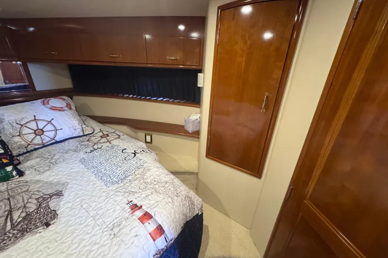 Slide: The Image of Luxurious cabin interior of 2004 Carver 466 Motor Yacht with nautical-themed bedding. - 35