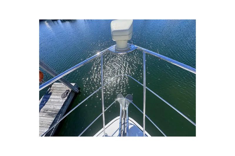 Slide: The Image of Bow view of 2004 Carver 466 Motor Yacht on sparkling water. - 42