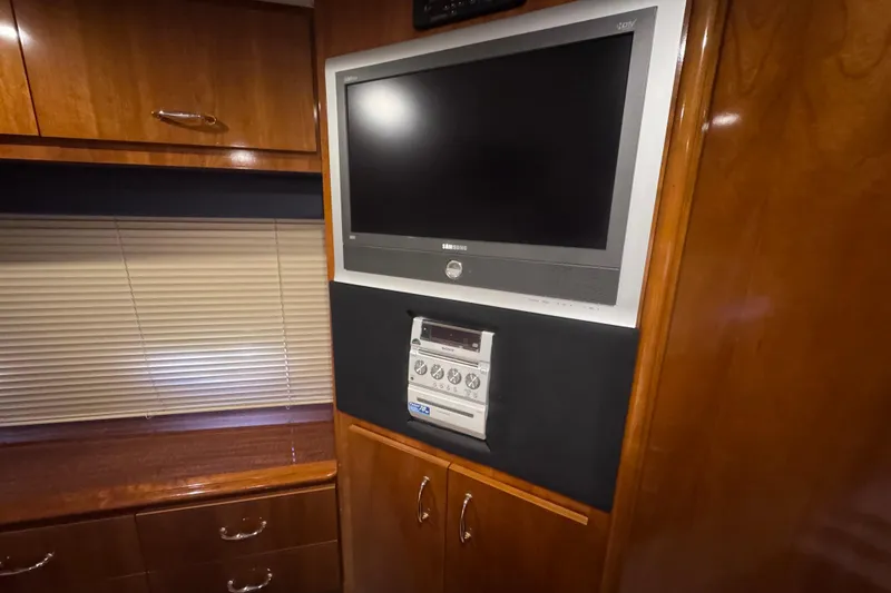Slide: The Image of Interior of 2004 Carver 466 Motor Yacht with TV and stereo system. - 26