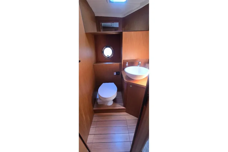 Slide: The Image of Bathroom interior of 2021 Beneteau Swift Trawler 41 Fly with wooden finish. - 9