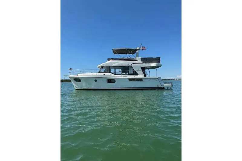 Slide: The Image of 2021 Beneteau Swift Trawler 41 Fly on calm water under clear blue sky. - 1