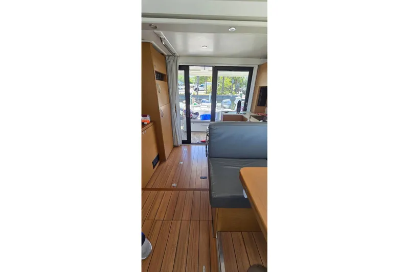 Slide: The Image of Interior of 2021 Beneteau Swift Trawler 41 Fly, featuring sleek wood flooring and modern seating. - 6