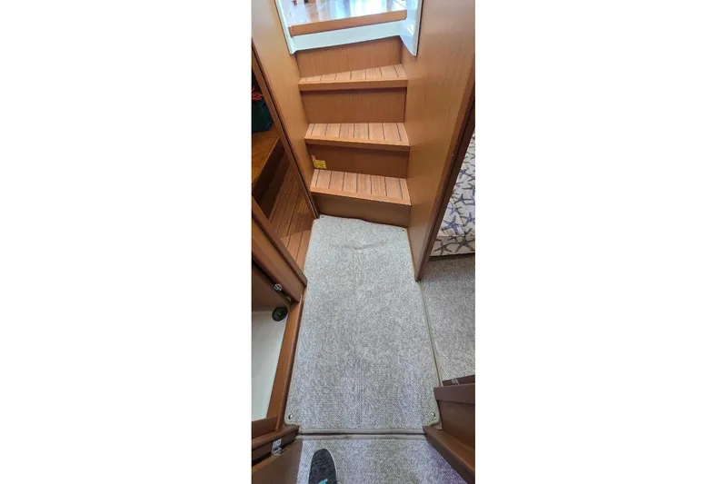 Slide: The Image of Interior stairs of 2021 Beneteau Swift Trawler 41 Fly with carpeted flooring. - 13