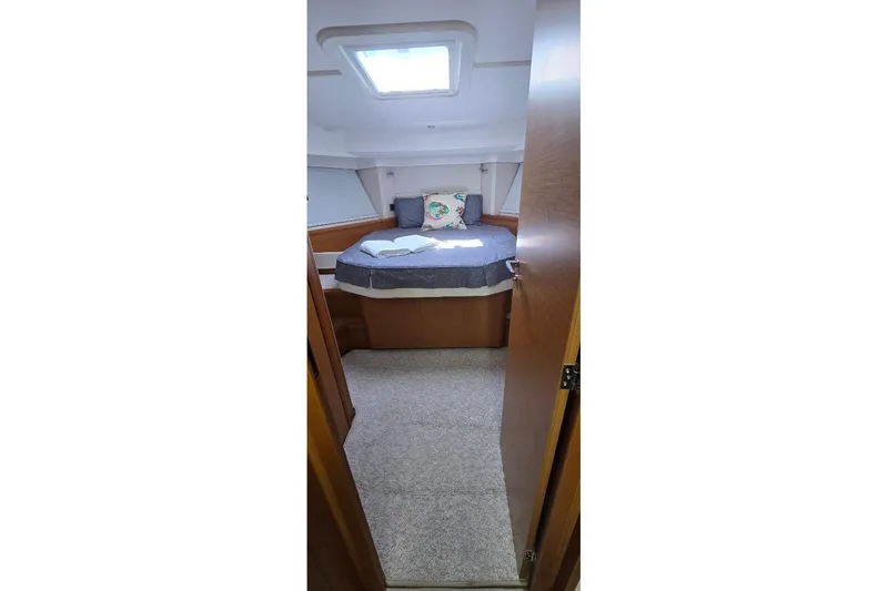 Slide: The Image of Cozy cabin interior of 2021 Beneteau Swift Trawler 41 Fly with bed and skylight. - 11