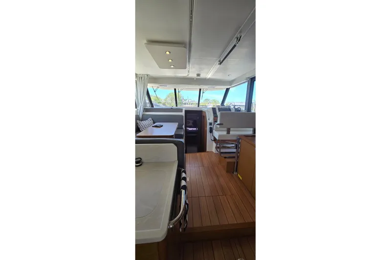 Slide: The Image of Interior of 2021 Beneteau Swift Trawler 41 Fly, featuring modern seating and wooden flooring. - 7