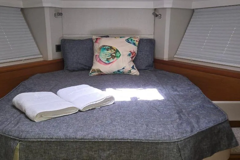 Slide: The Image of Cozy bedroom in 2021 Beneteau Swift Trawler 41 Fly with nautical decor. - 12
