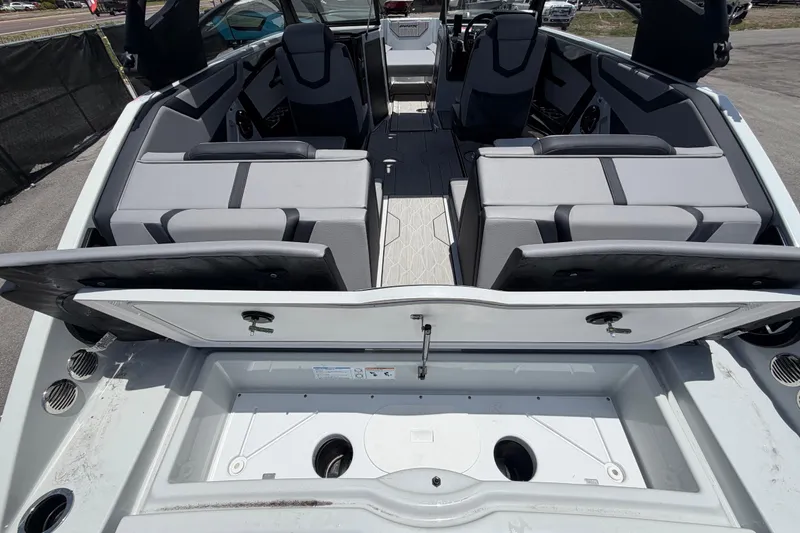 Slide: The Image of 2024 Yamaha Boats 222XD interior with open storage compartments and seating. - 12