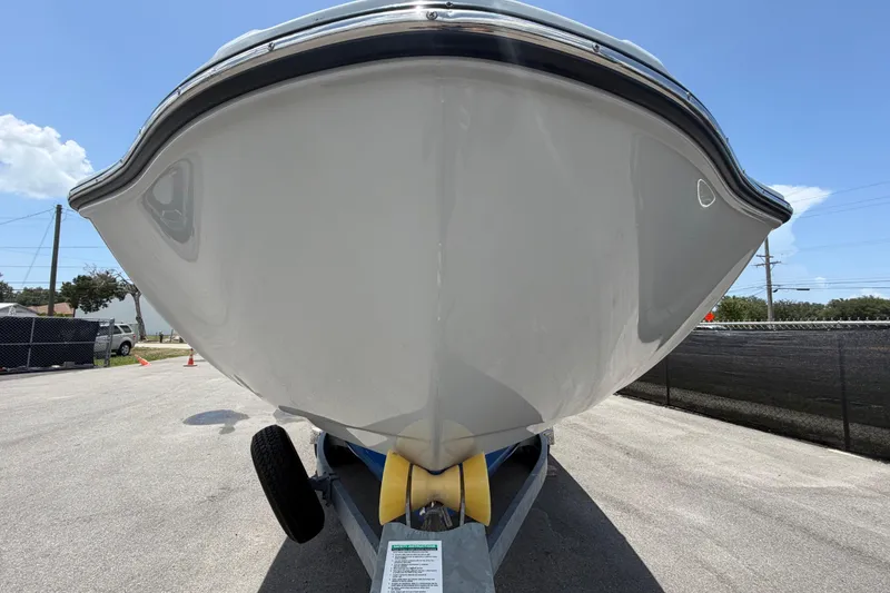 Slide: The Image of 2024 Yamaha Boats 222XD on trailer, viewed from the front under a clear sky. - 8