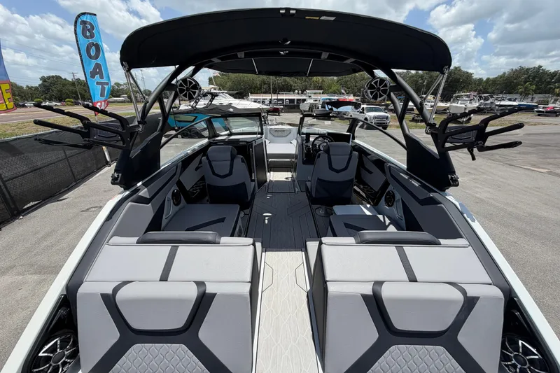 Slide: The Image of 2024 Yamaha Boats 222XD interior with sleek seating and modern design under a sunny sky. - 10