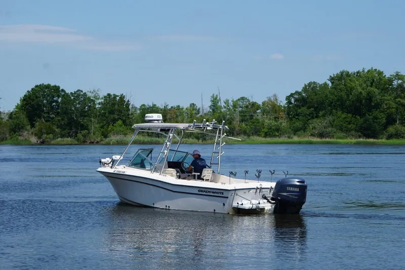 Slide: The Image of 1999 Grady-White Tournament 225 boat on calm water with Yamaha outboard motor. - 11