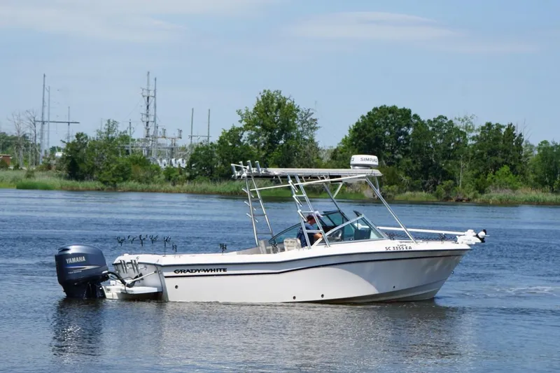 Slide: The Image of 1999 Grady-White Tournament 225 boat cruising on a calm river with Yamaha engine. - 2