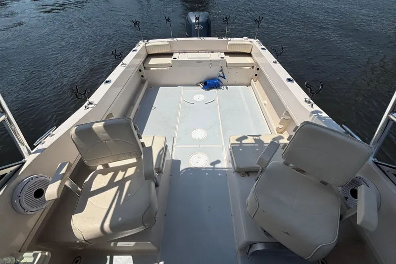 Slide: The Image of 1999 Grady-White Tournament 225 boat interior with seating and fishing rod holders. - 15