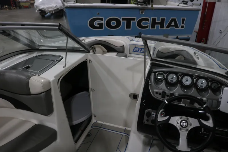Slide: The Image of 2009 Yamaha Boats 212X interior with steering wheel and dashboard gauges. - 17